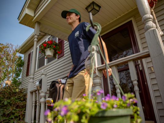 A contractor walking down the steps of a home